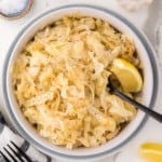 Sautéed cabbage in a bowl with a spoon.