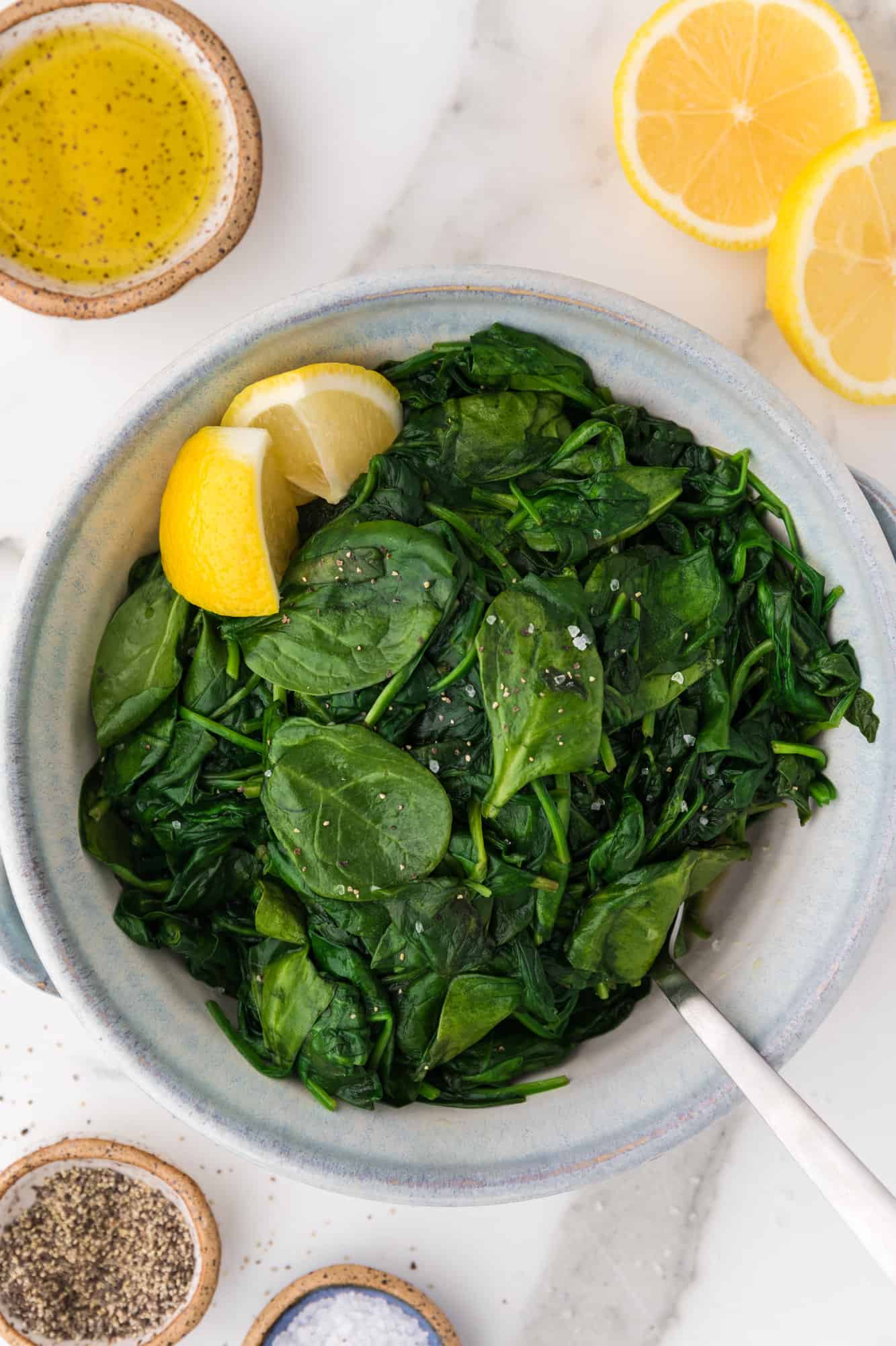Sautéed spinach in a white bowl.
