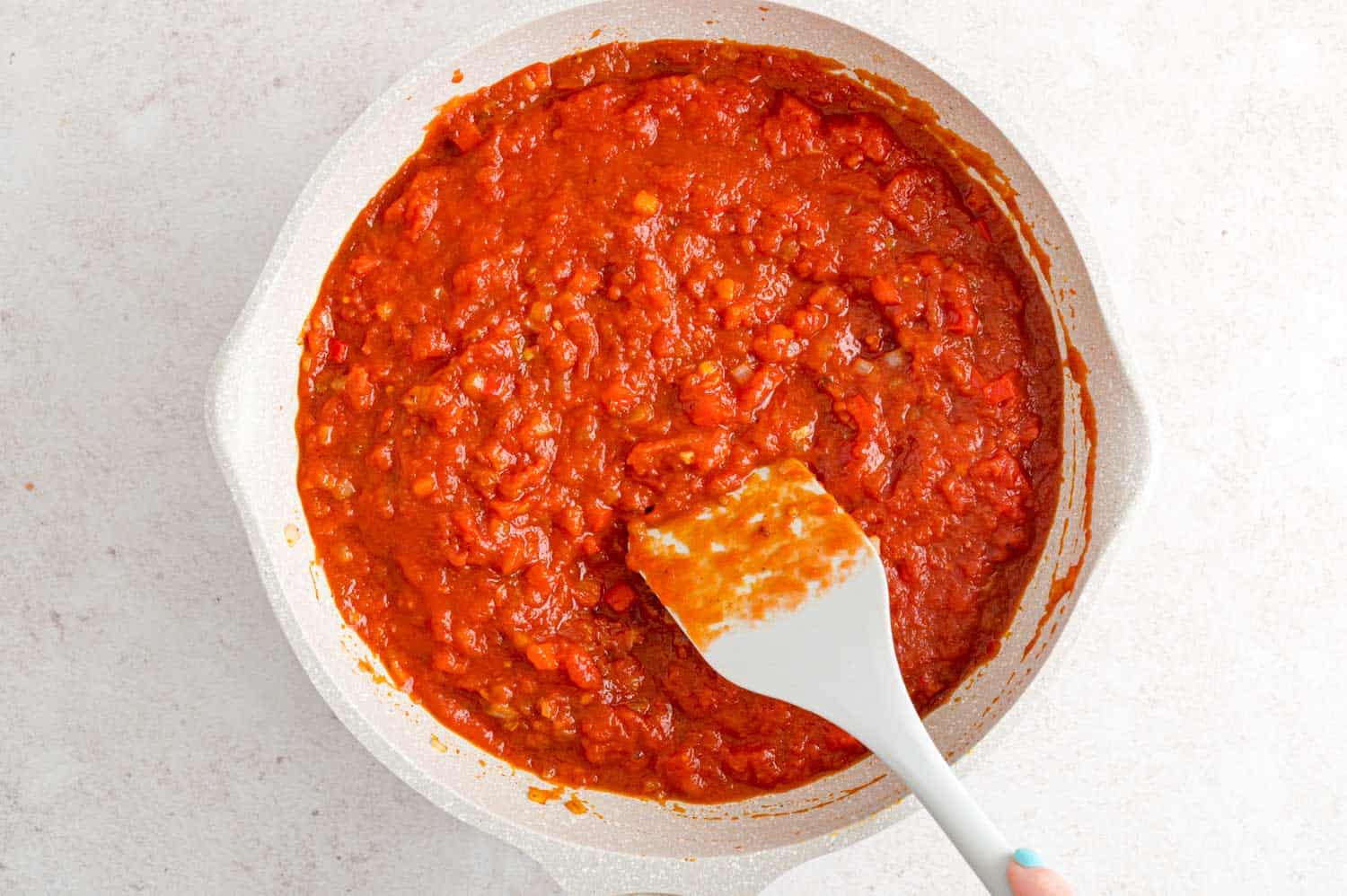 Crushed tomatoes added to pan.