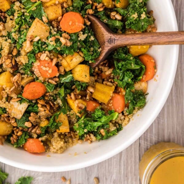Warm kale salad with quinoa and candied sunflower seeds.