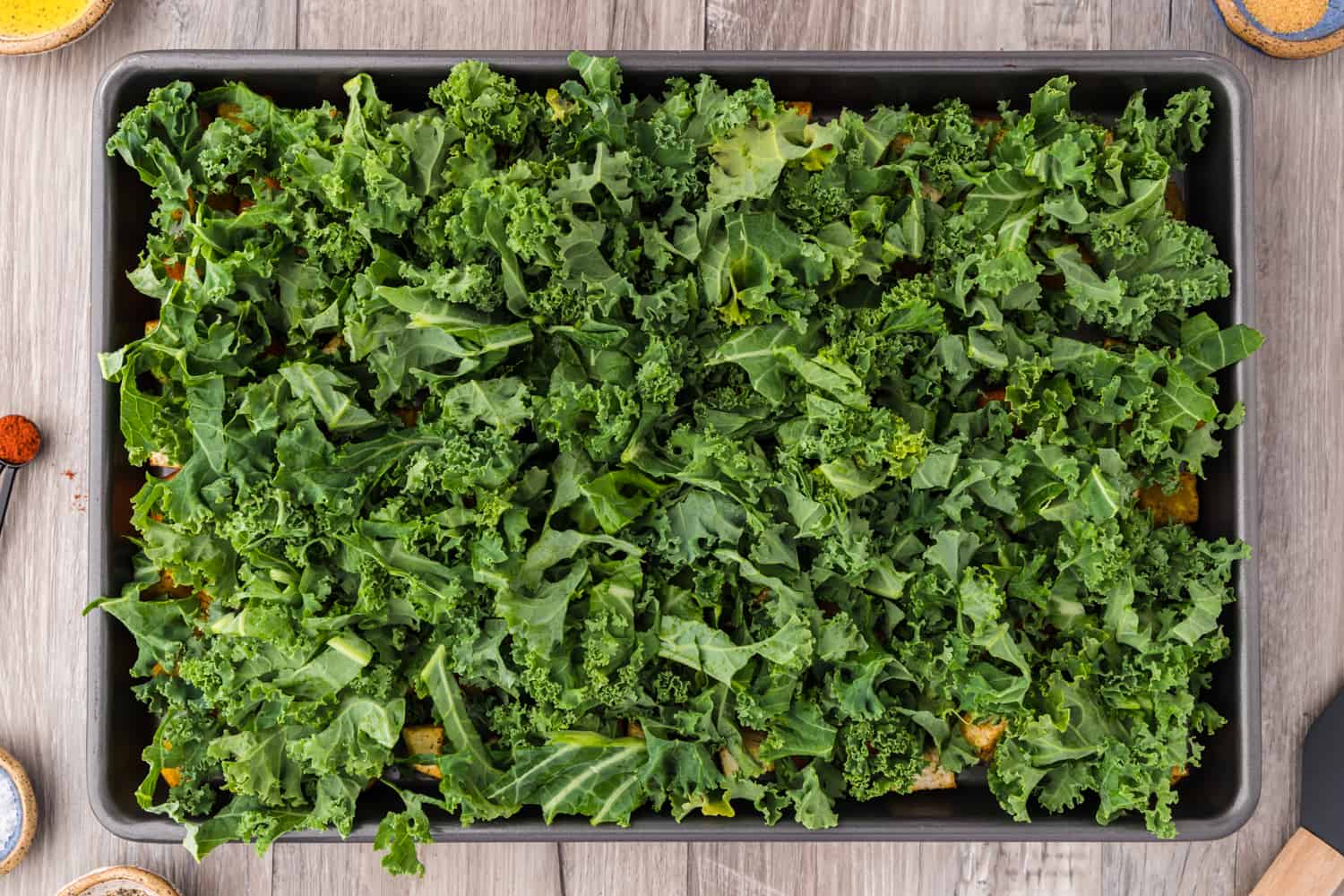 Kale added to sheet pan.