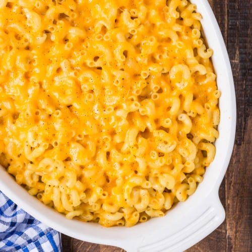 Baked mac and cheese in a white oval casserole dish.