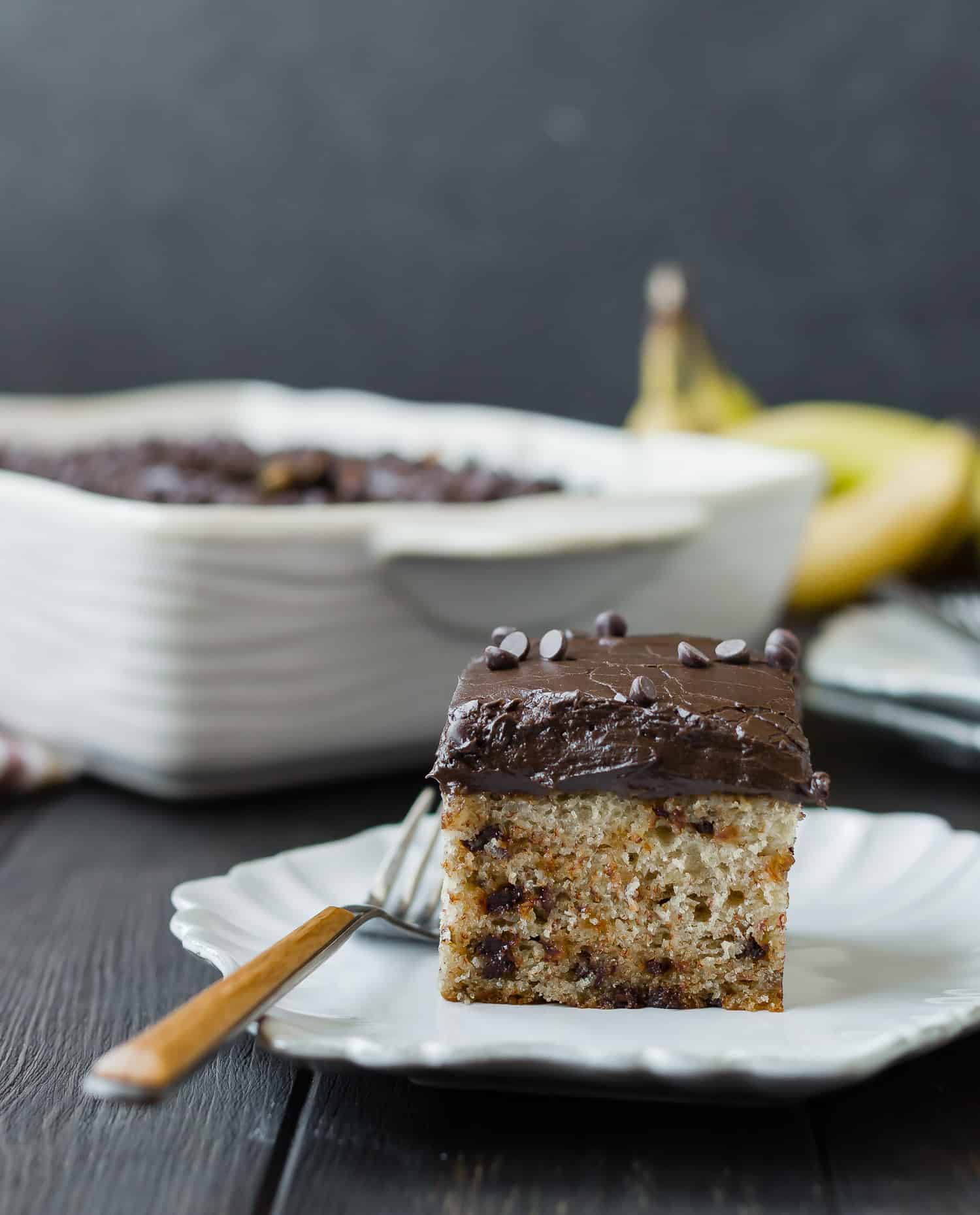 Slice of cake with thick chocolate frosting.