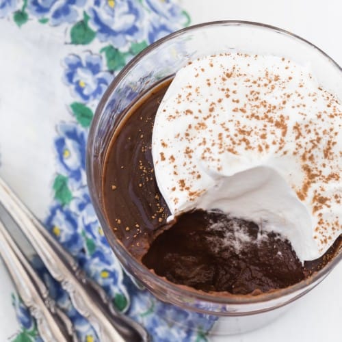 Chocolate pudding topped with whipped cream.