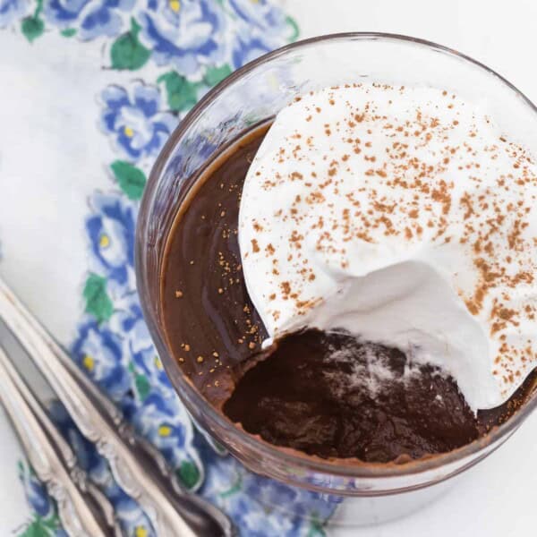 Chocolate pudding topped with whipped cream.