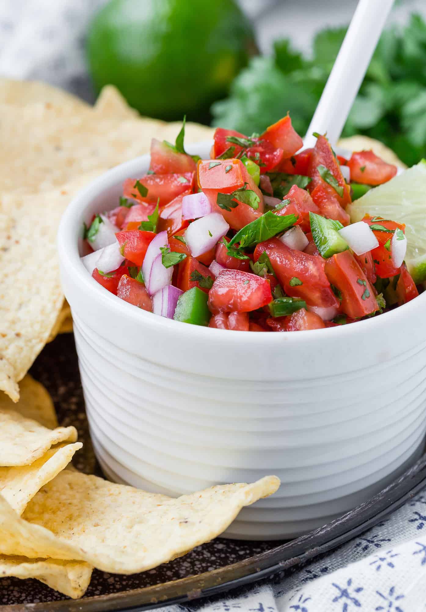 Fresh salsa in a bowl surrounded by chips.