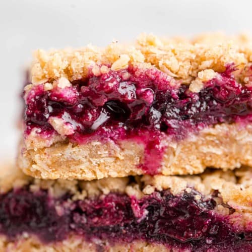Blueberry crumble bars stacked on top of each other.