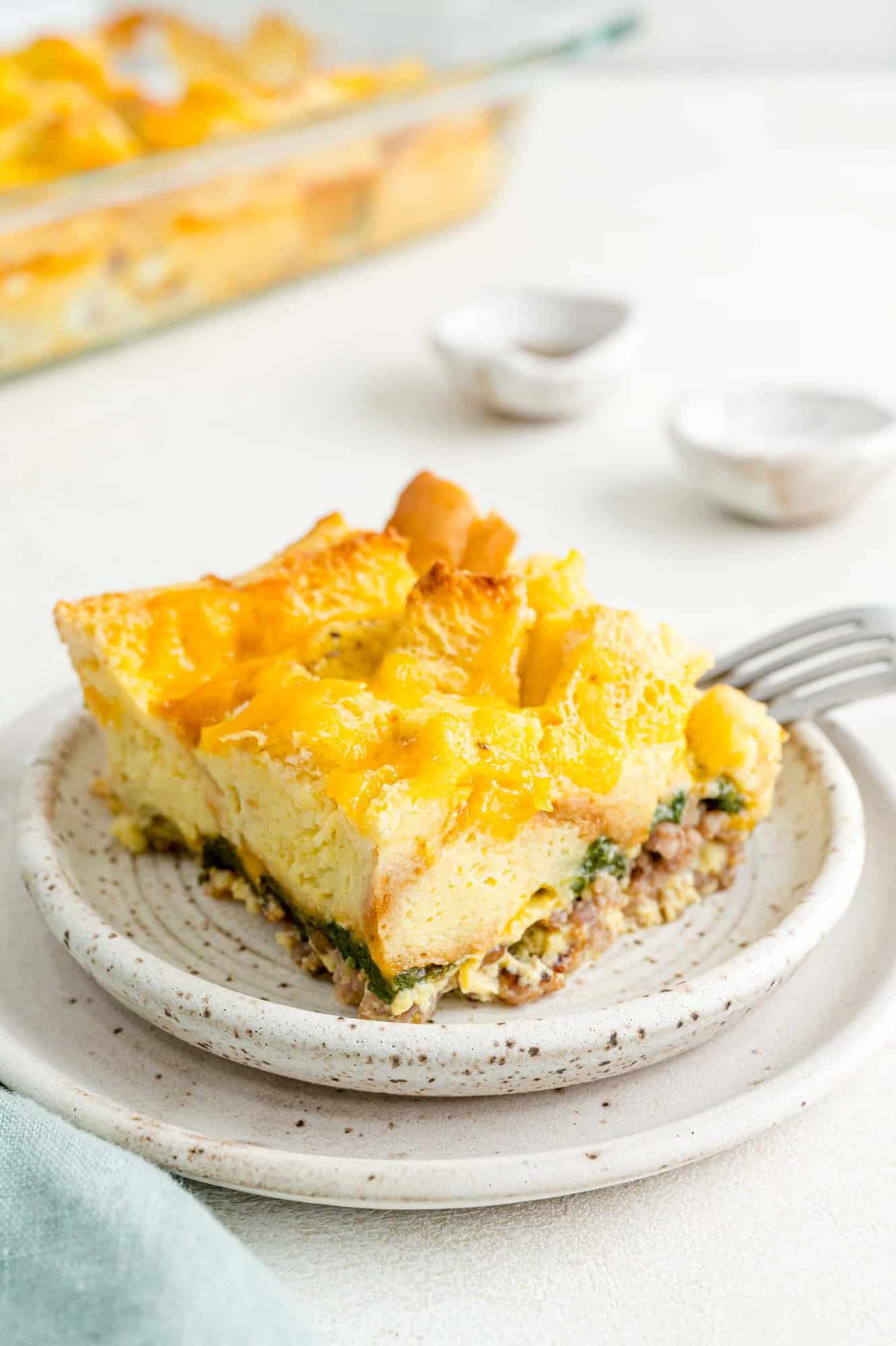 Square of casserole on a white plate.