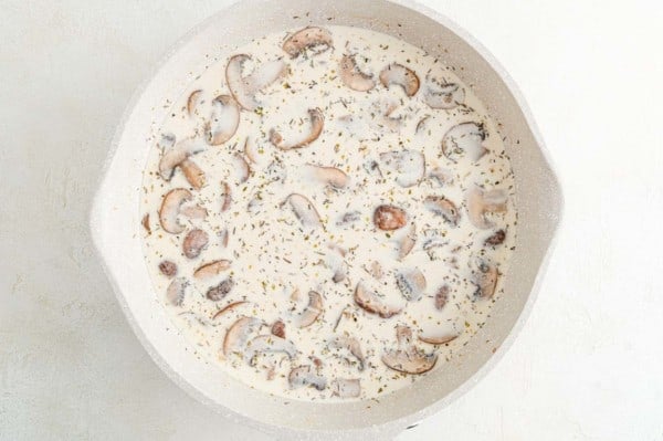 Creamy marsala sauce with mushrooms in a skillet.