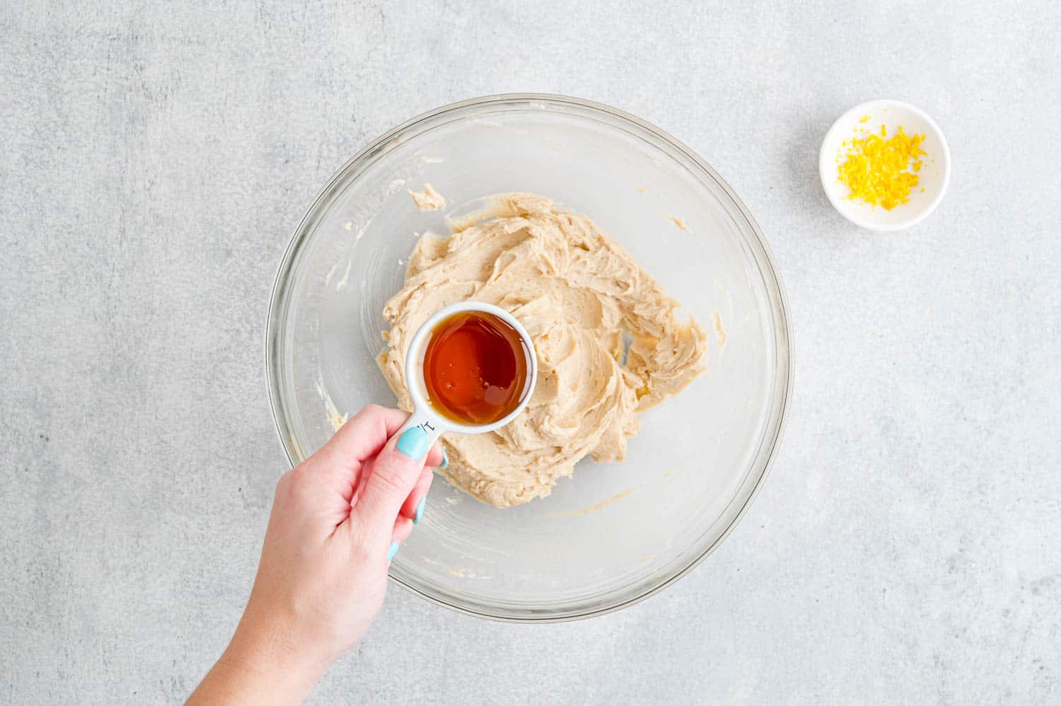 Honey being added to bowl.