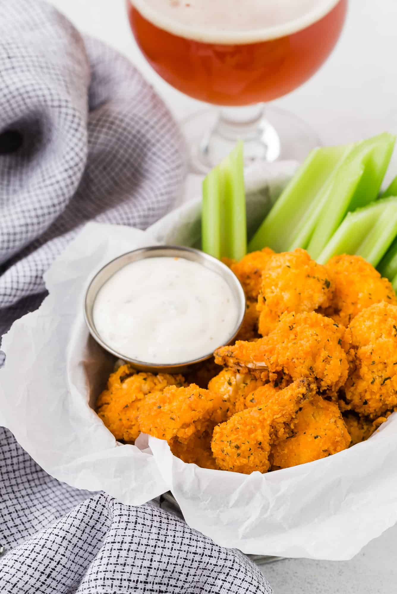 Wings with beer in background.