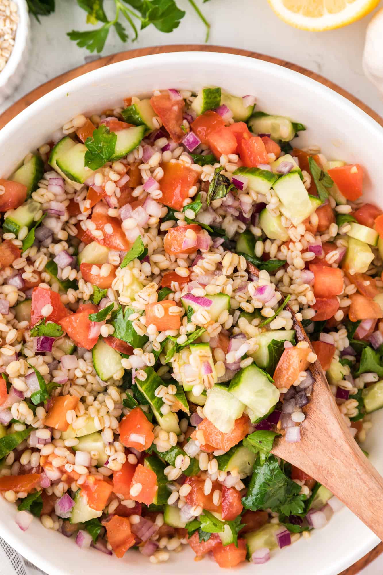 Barley salad with tomatoes, cucumbers, onions.