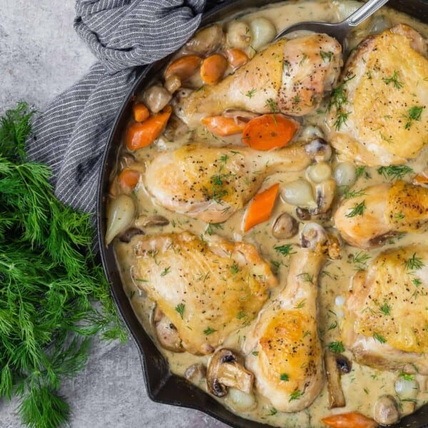 Chicken fricassee in a black skillet.