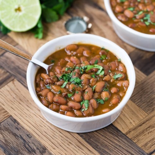 Drunken beans in a small white bowl