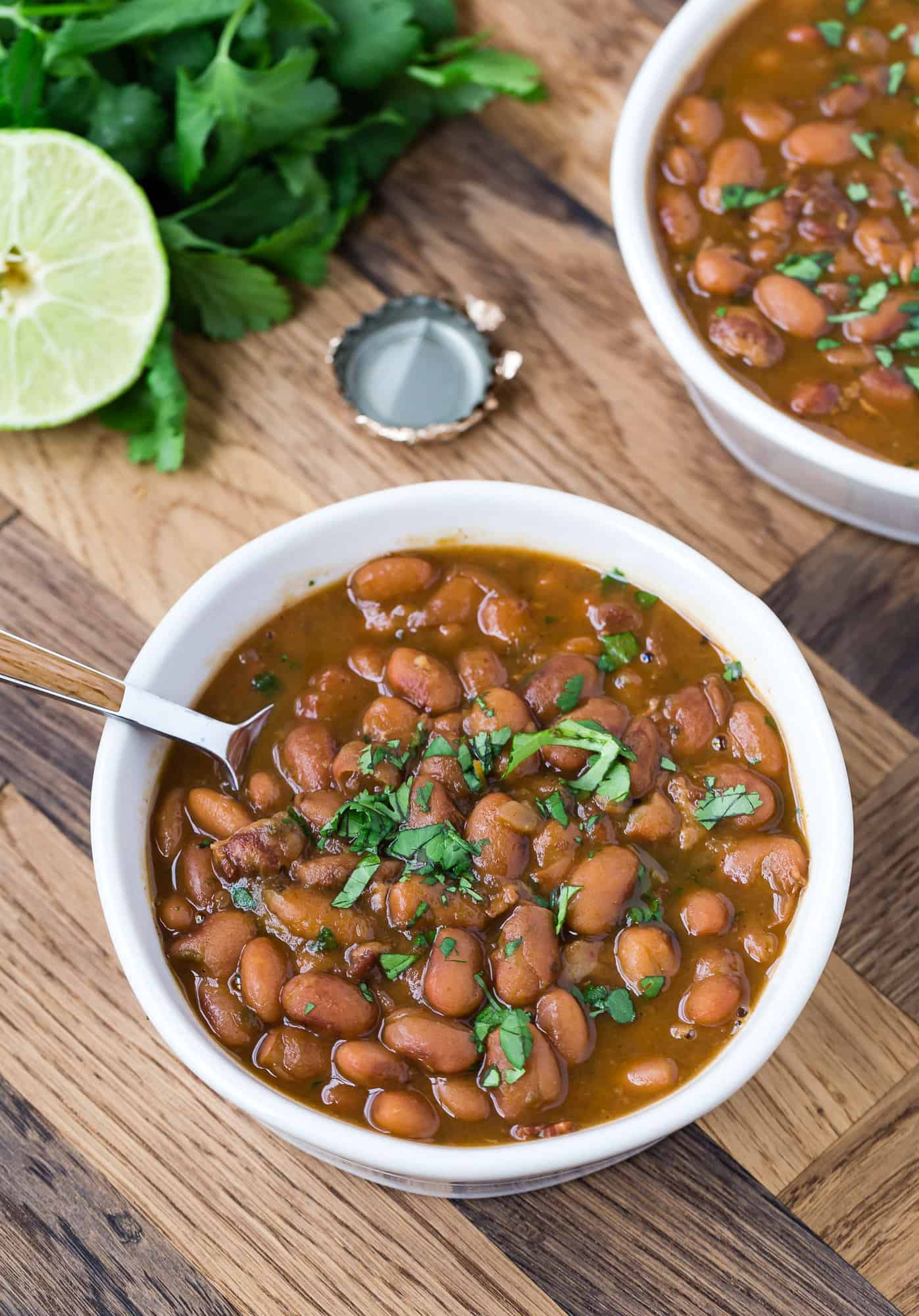 Drunken beans topped with cilantro in two bowls.