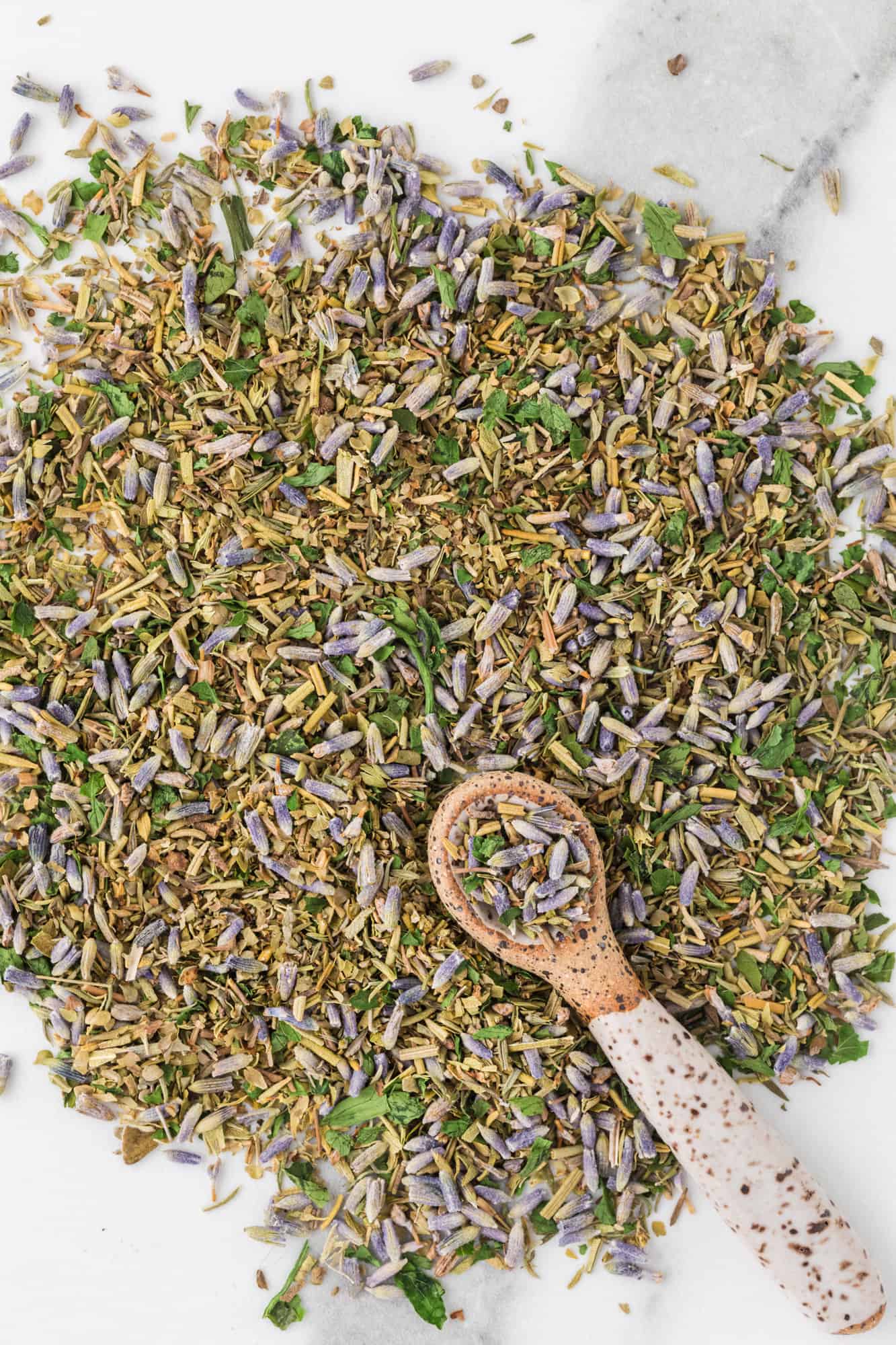 Herbs spread on a marble backdrop.