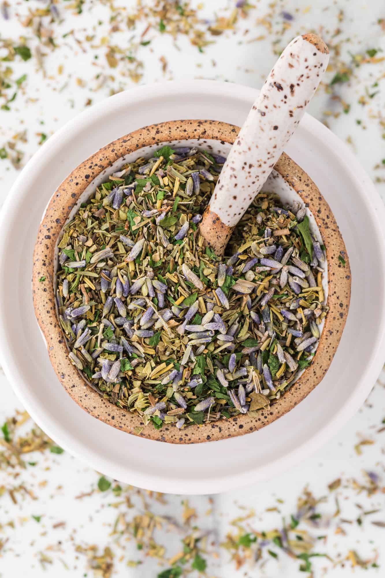 Herbes de Provence in a small bowl with a spoon.