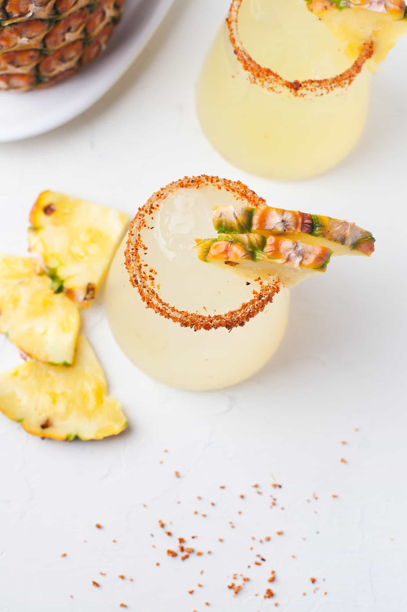 Pineapple margarita with chili rim, viewed from above.