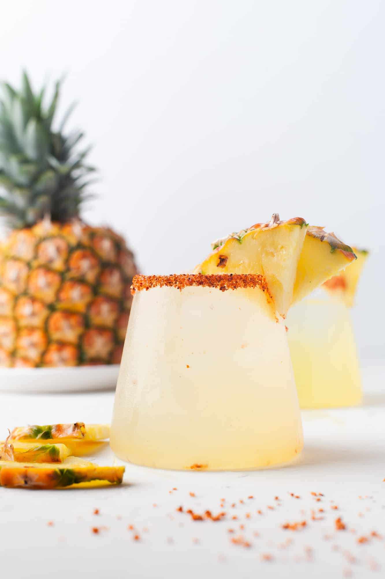 Pineapple margarita with a pineapple in the background.