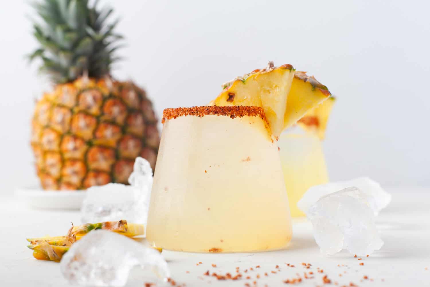 Pineapple margarita garnished with fresh pineapple.