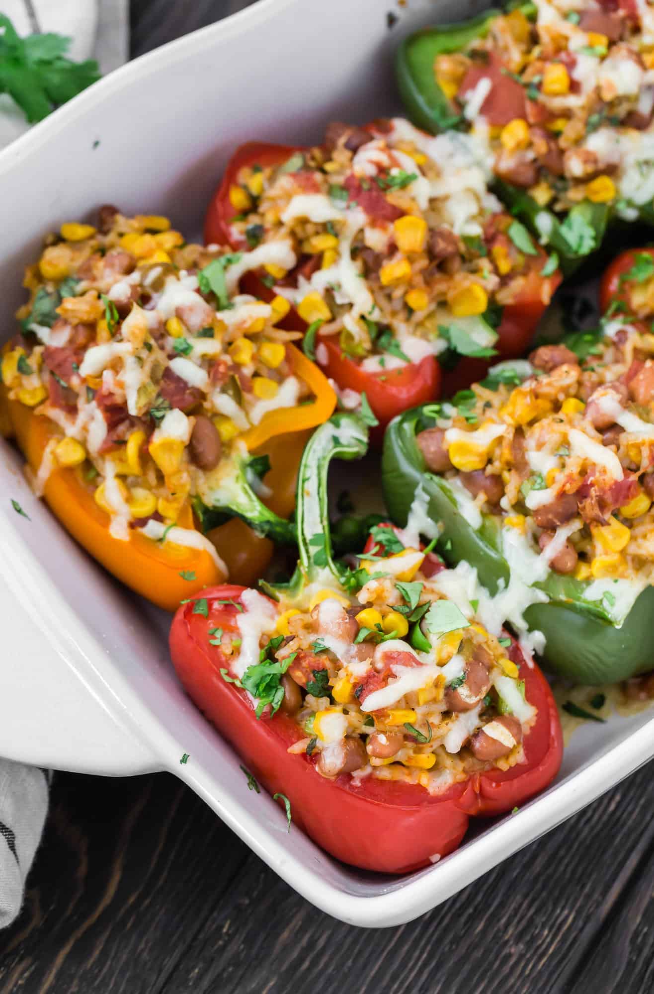 Stuffed bell peppers in a casserole dish.