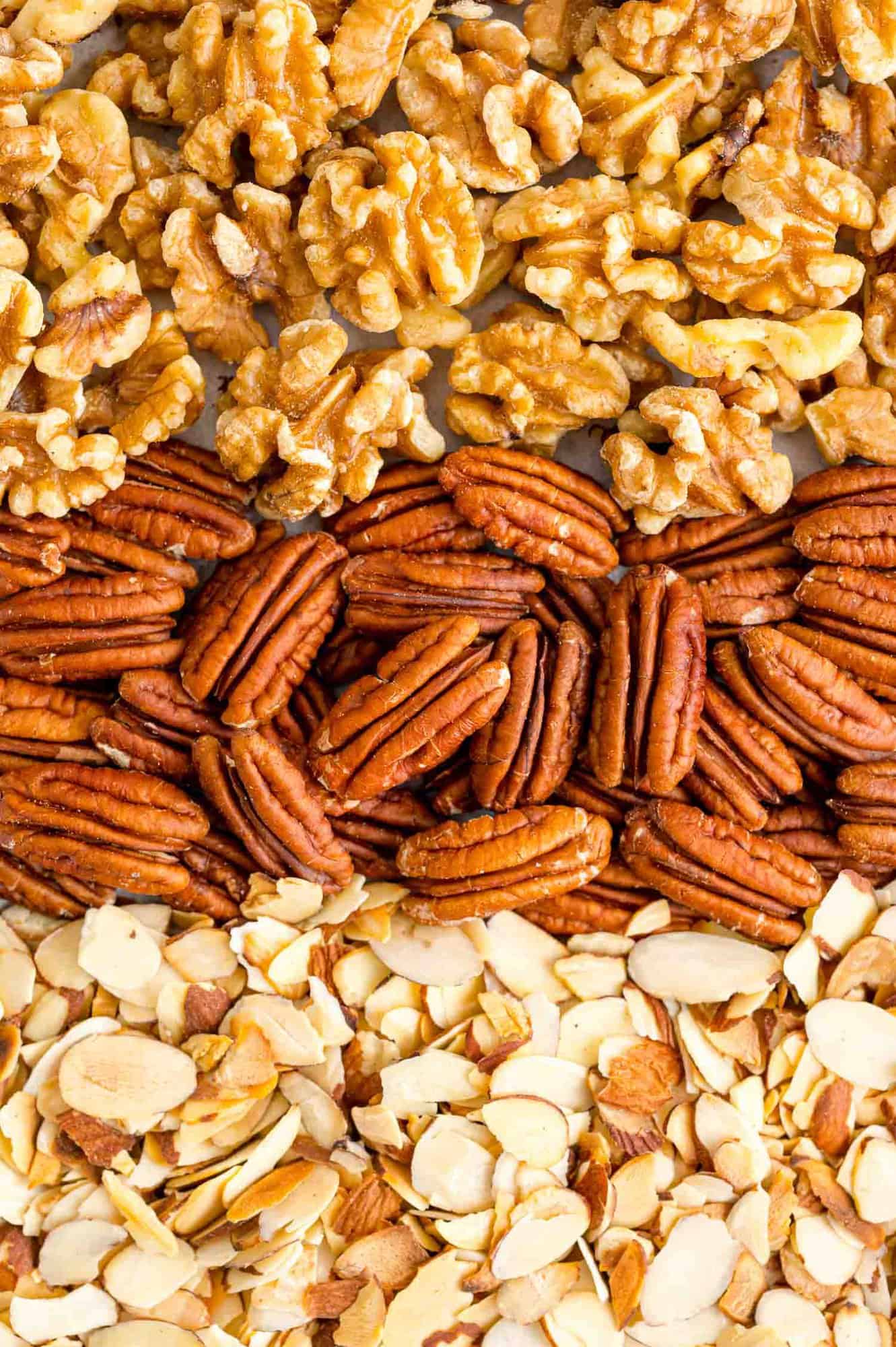 Three types of toasted nuts on a pan.