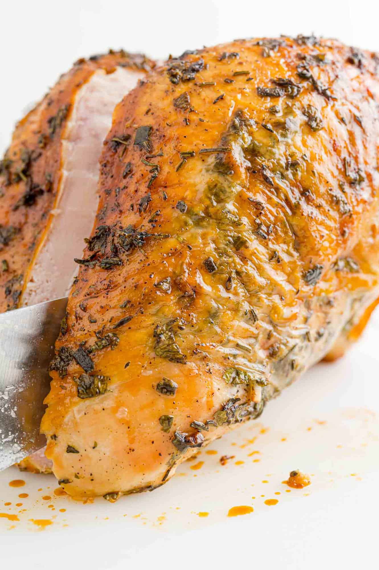 Turkey breast being sliced.
