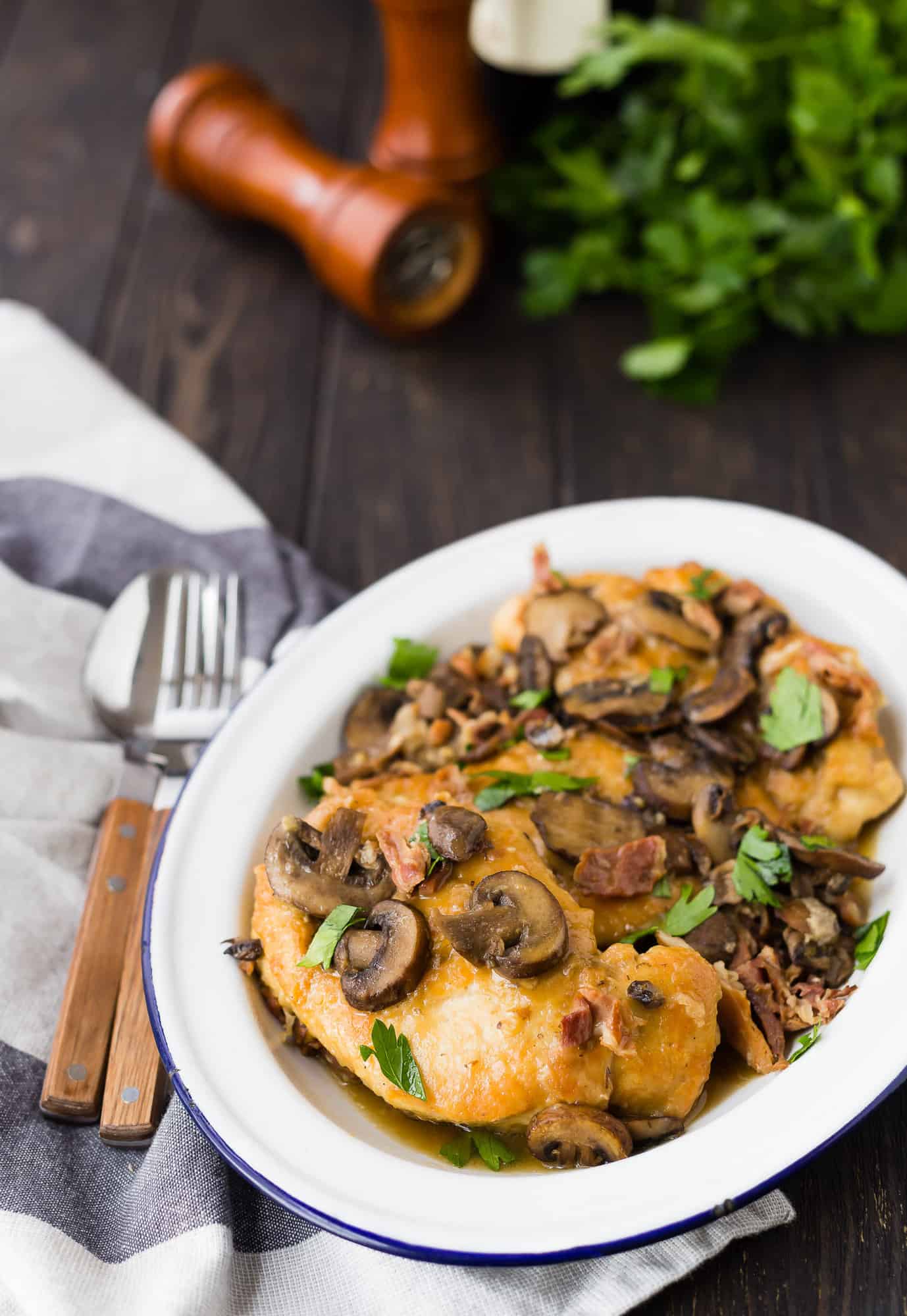 Chicken marsala on plate garnished with parsley.