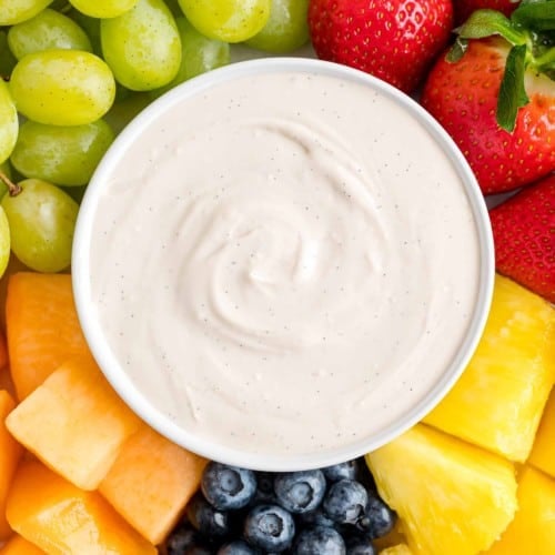 Cream cheese fruit dip surrounded by fresh fruit.
