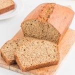 Loaf of healthy banana bread, partially cut into slices.