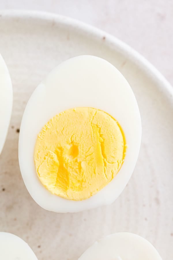 Close up of one half of a hard boiled egg on a plate.