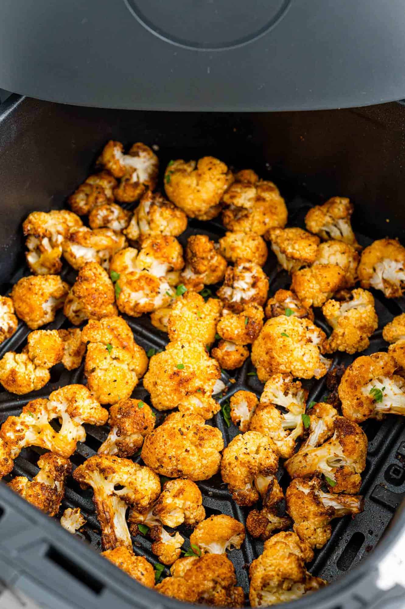 Crispy cauliflower inside the air fryer basket.