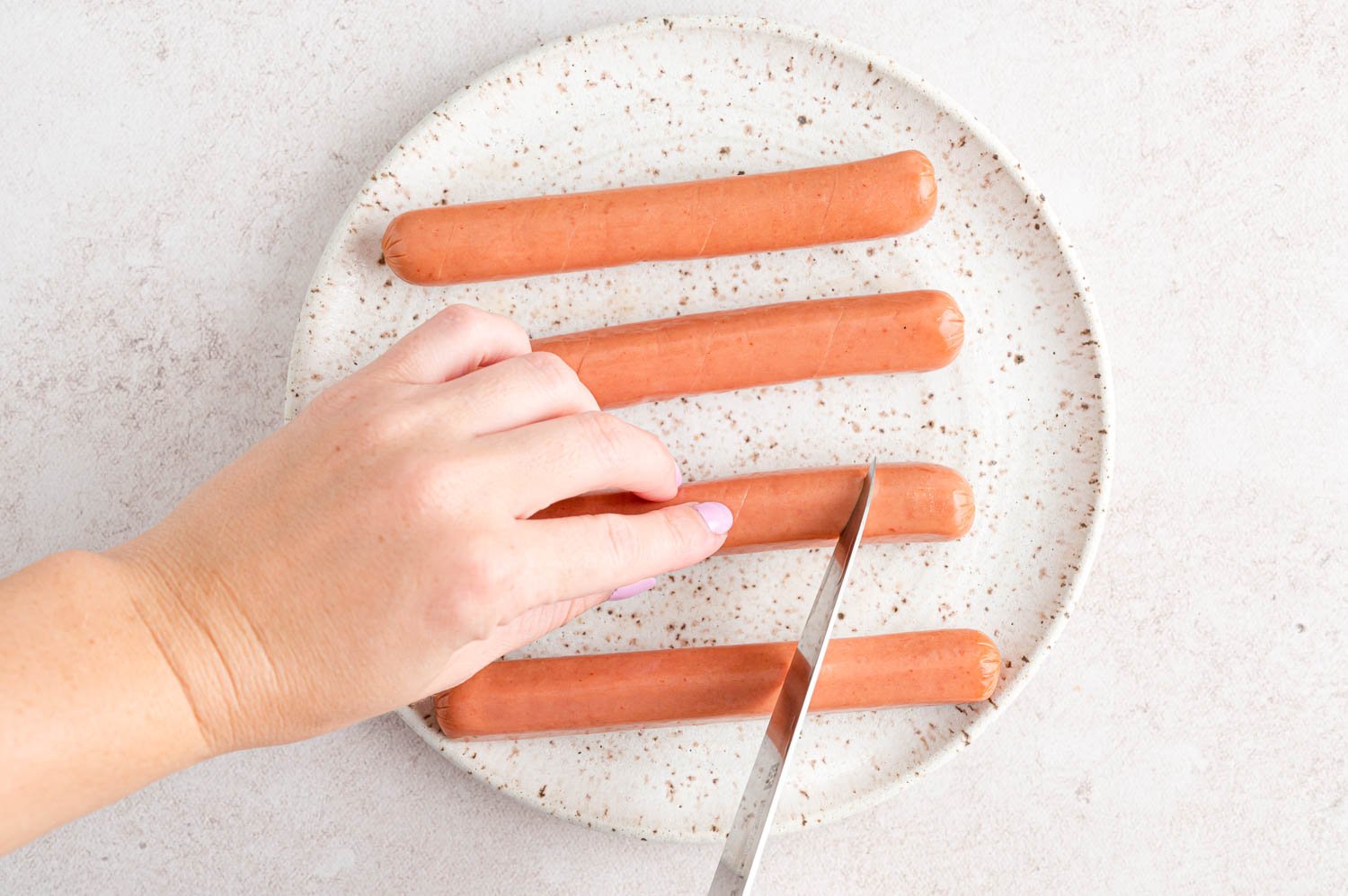 Slices being cut in a hot dog.