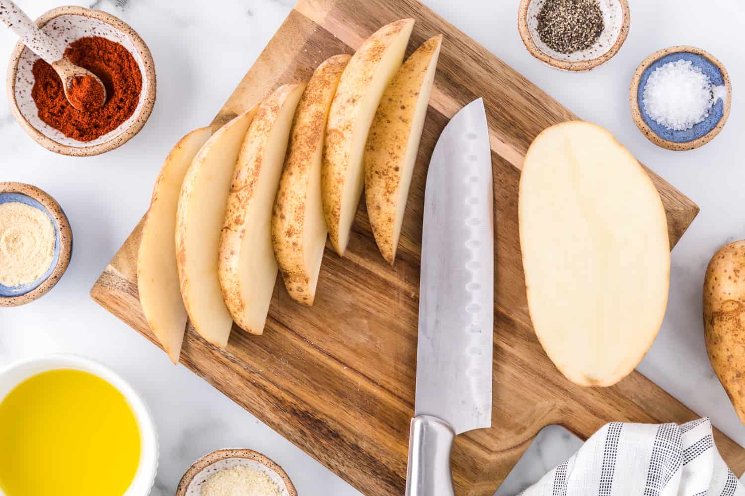 Potato being cut into wedges.