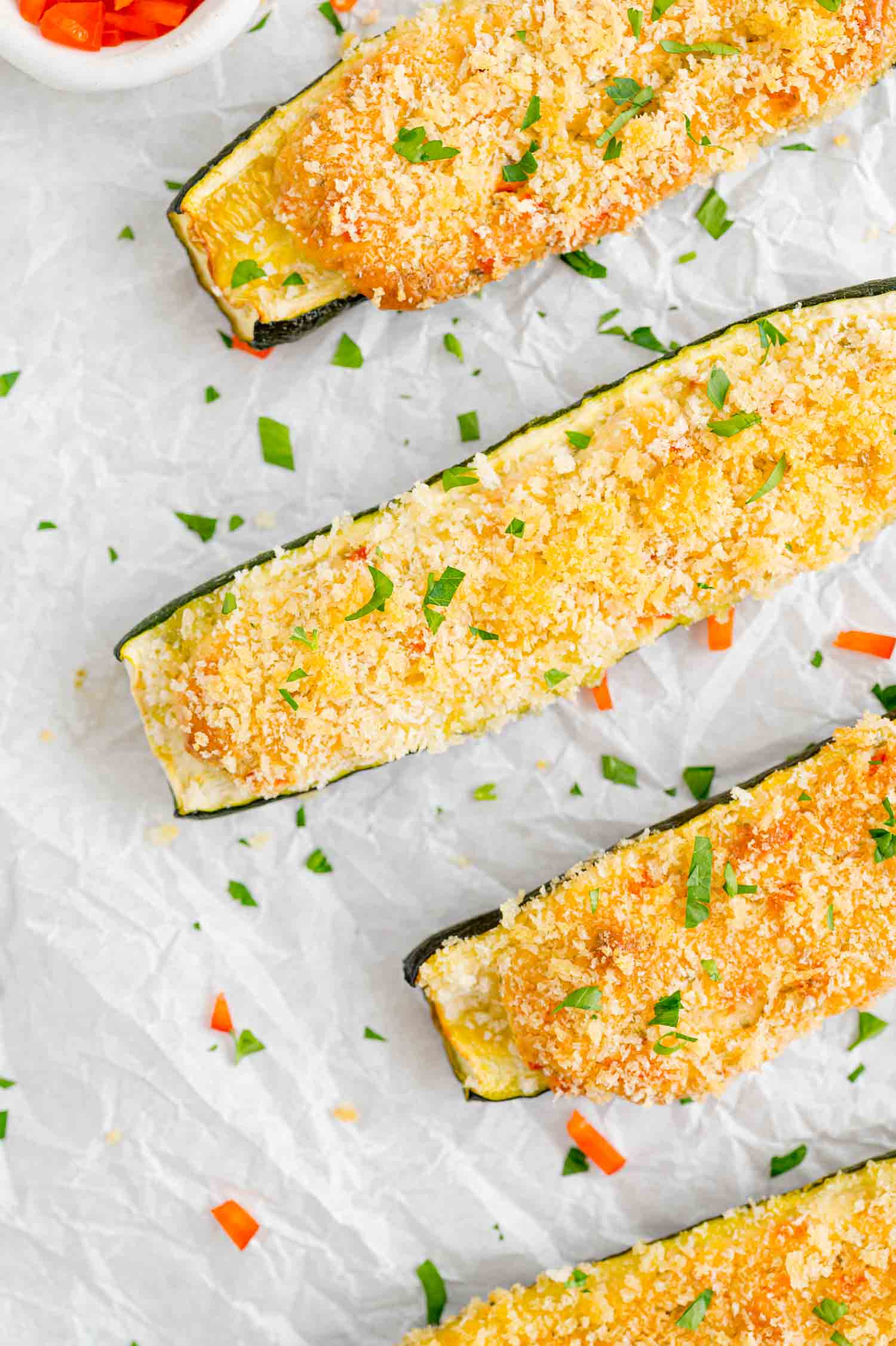 Baked zucchini halves on a sheet pan.