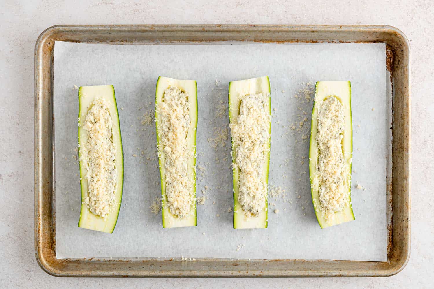 Stuffed zucchini halves but not yet cooked.