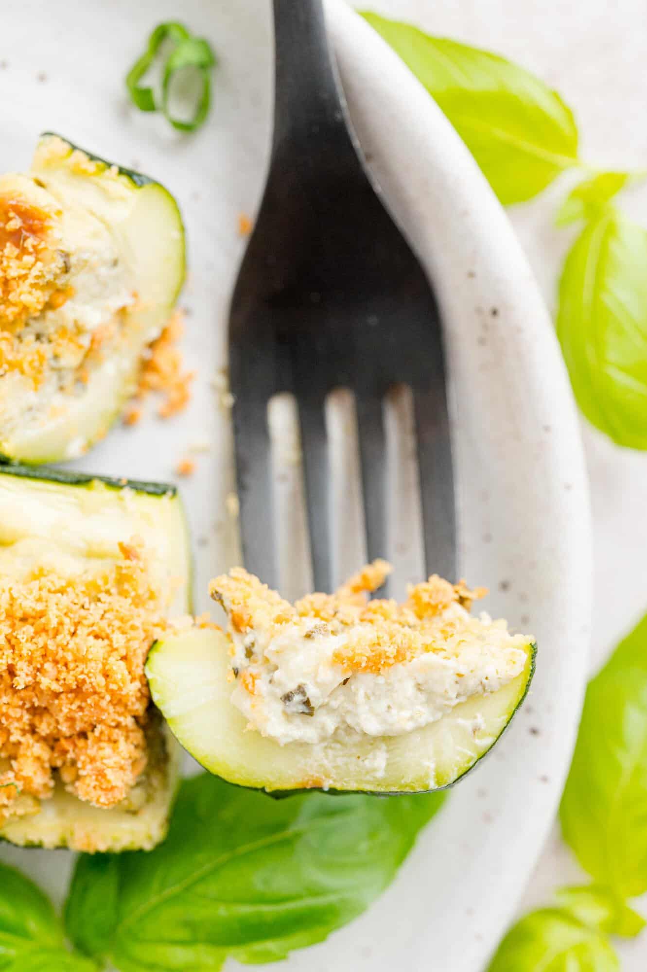 Cheese stuffed zucchini on a fork.