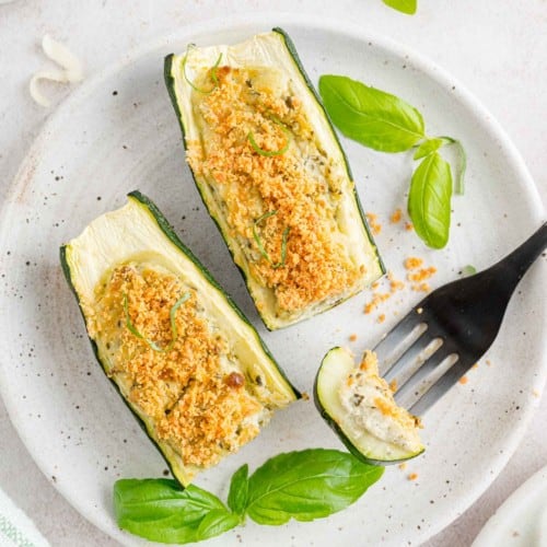 Cheese and pesto stuffed zucchini, cut to show filling.