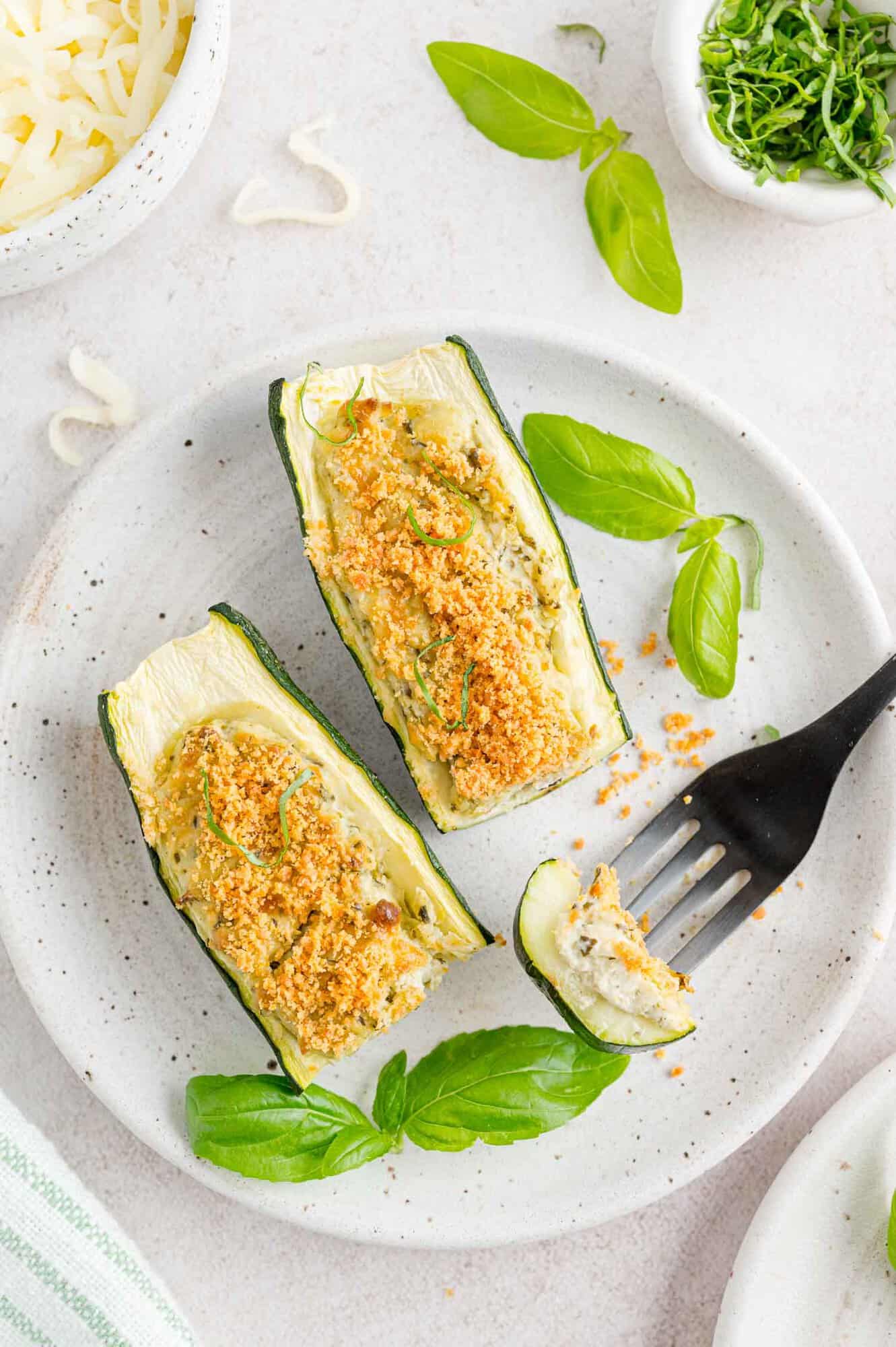 Cheese and pesto stuffed zucchini, cut to show filling.