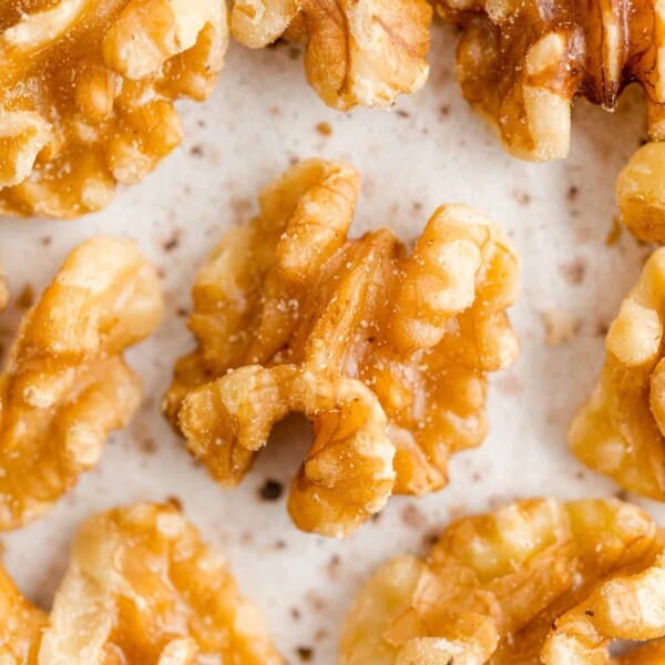 Walnut halves on a speckled background.