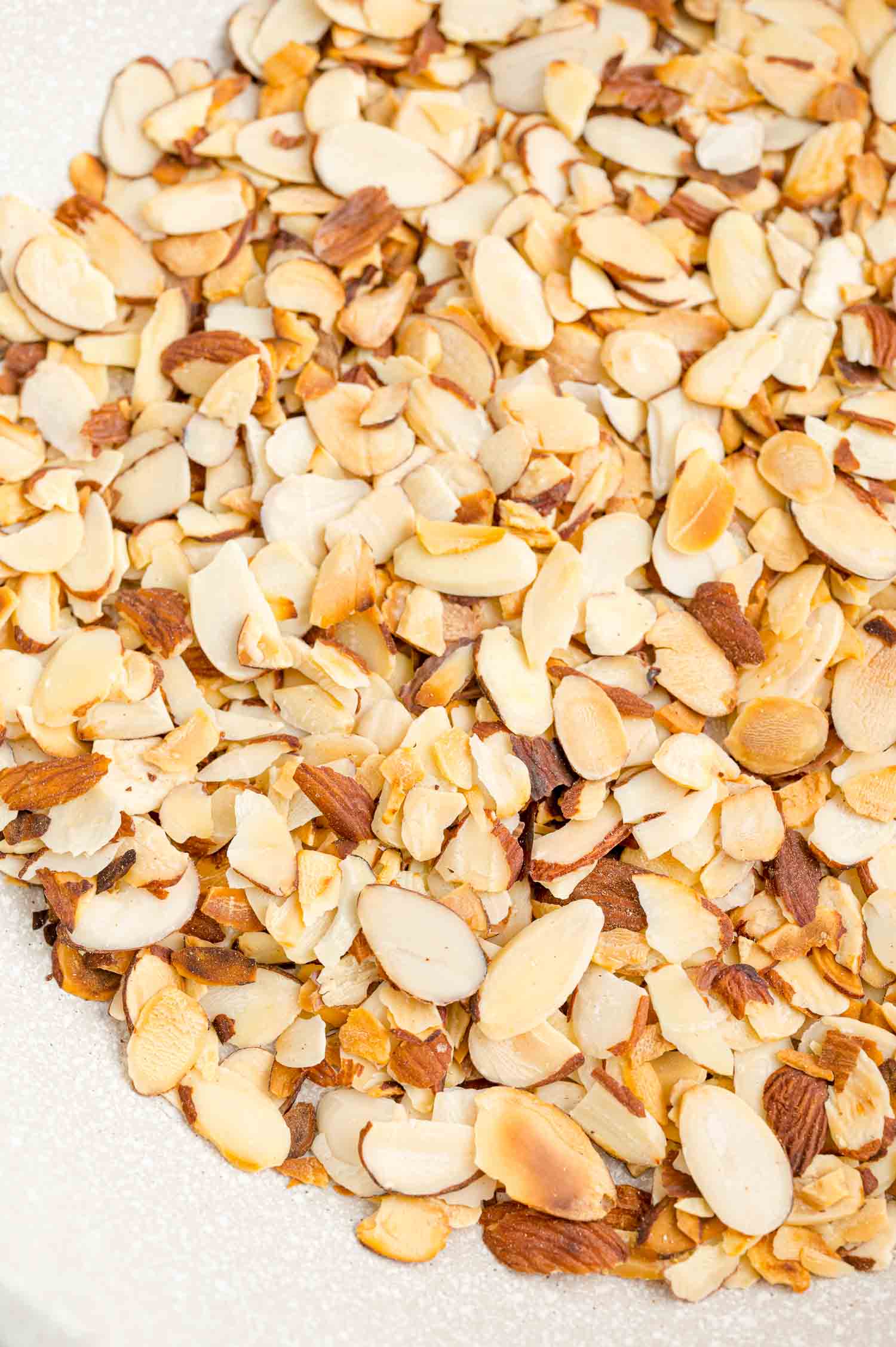 Close up of toasted almonds in a bowl.