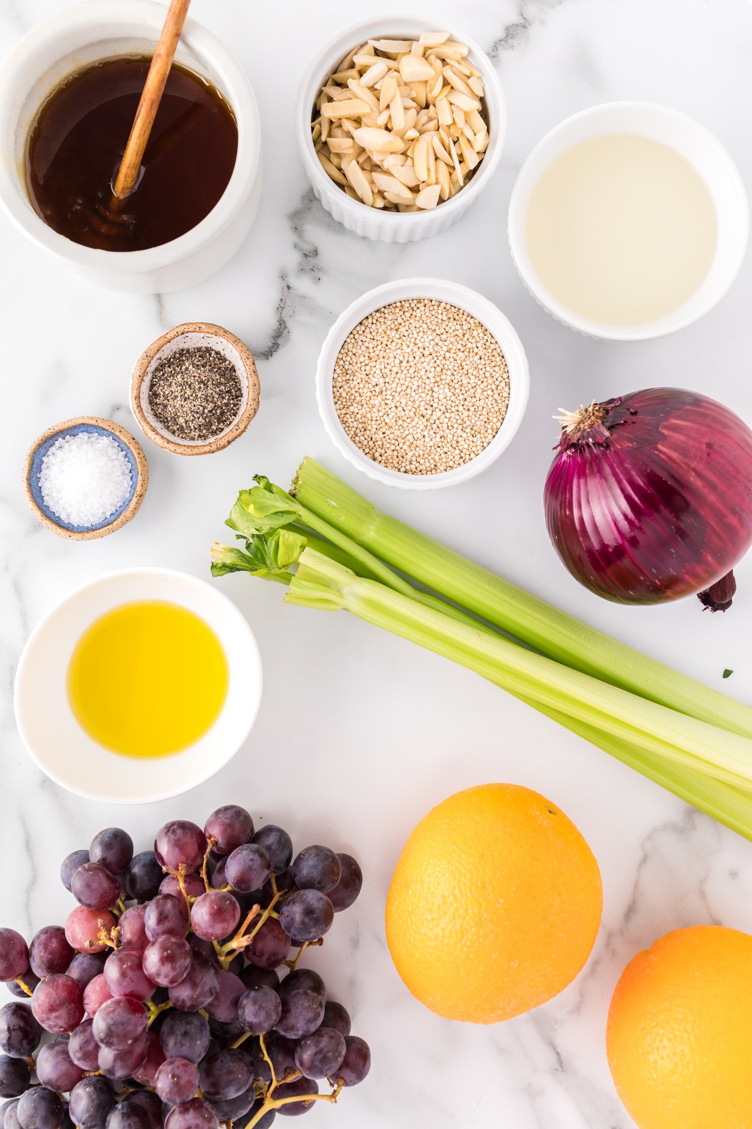 Ingredients needed for the recipe, including onion, grapes, quinoa.