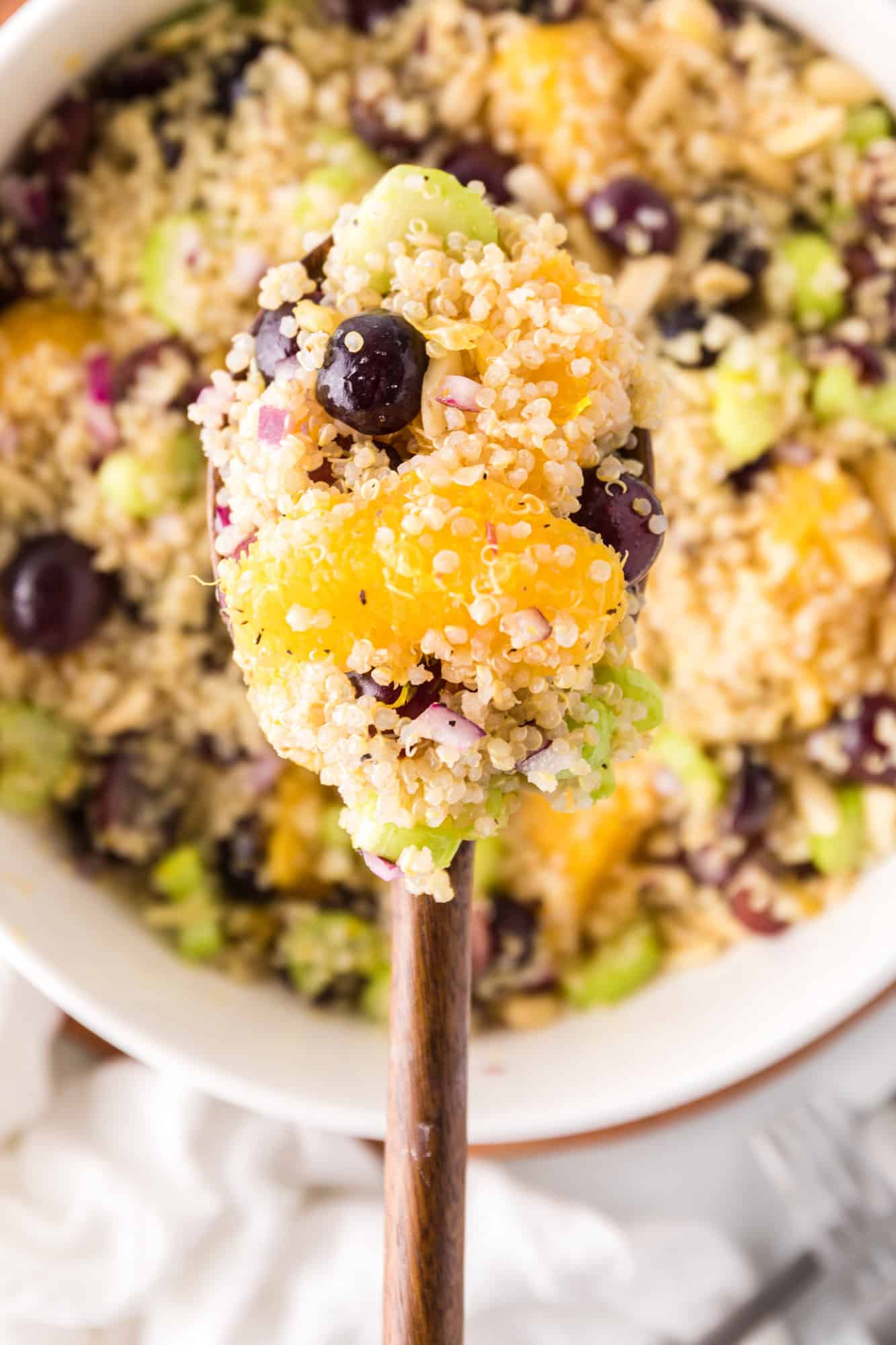 Quinoa salad on serving spoon.