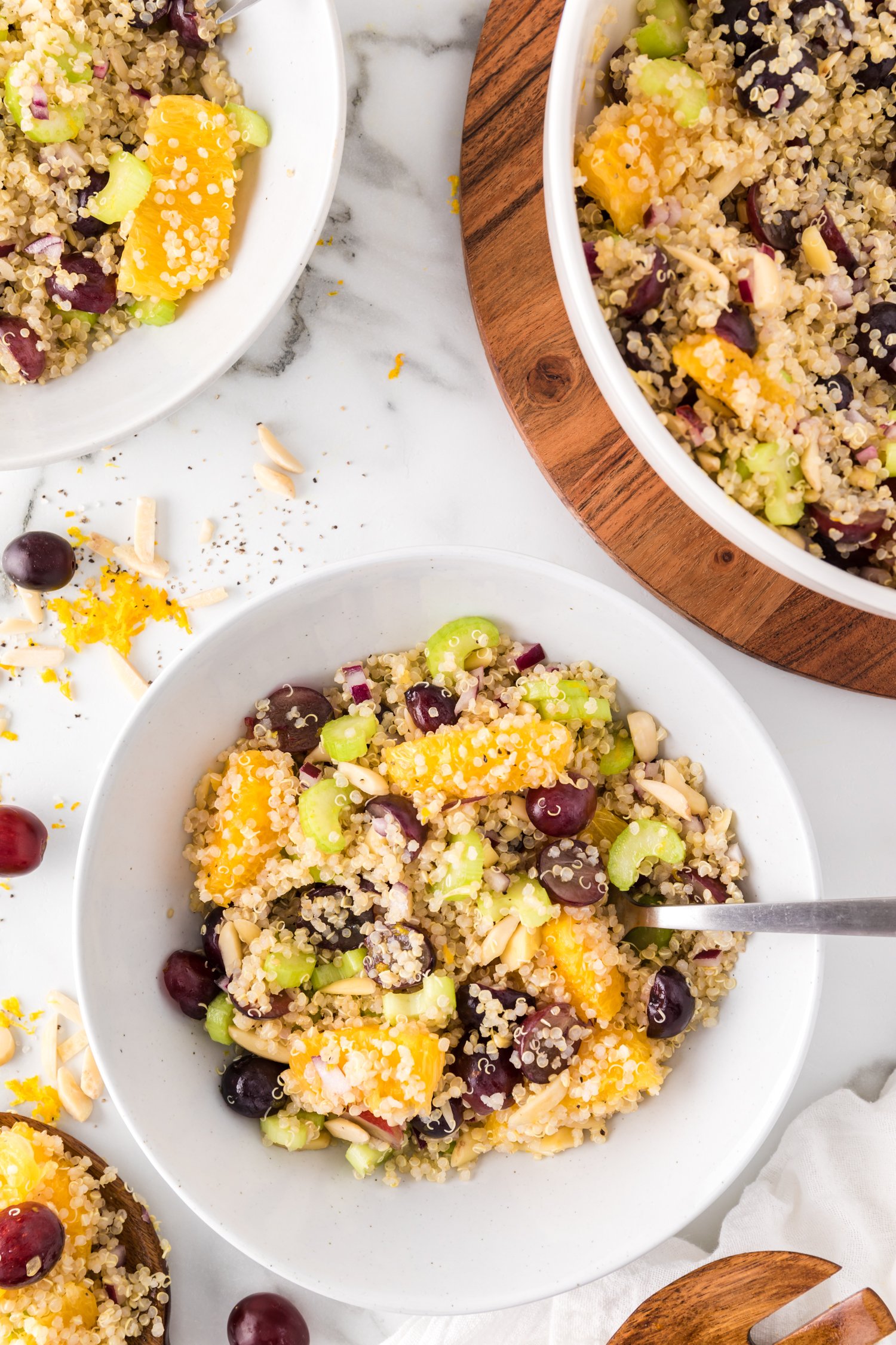 Salad in a small bowl, next to a larger serving bowl of salad.