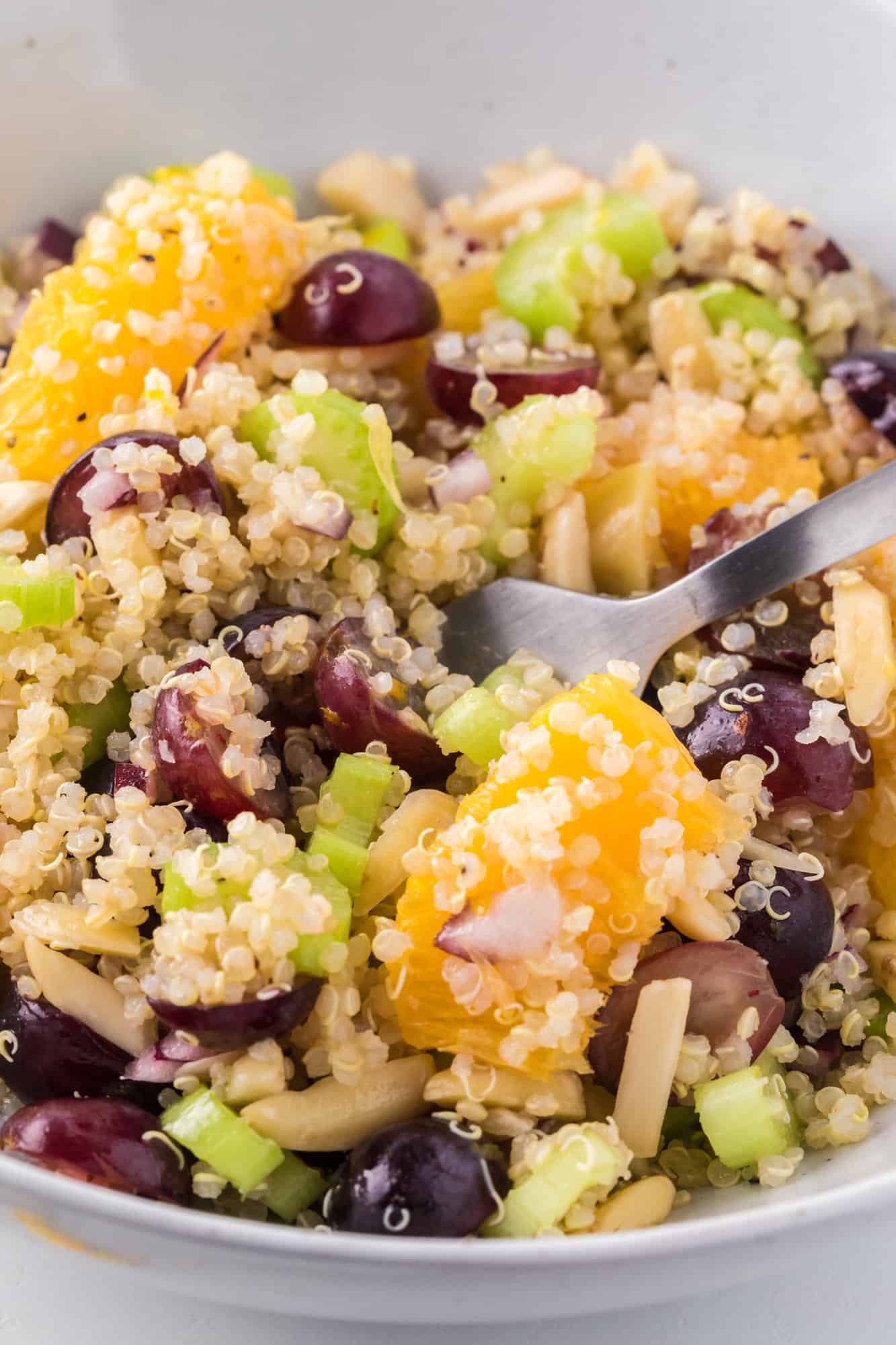 Close up of salad on fork.