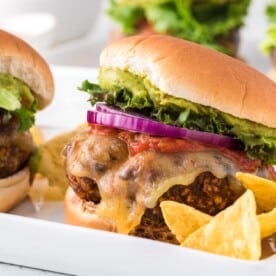 Taco turkey burger with toppings and chips.