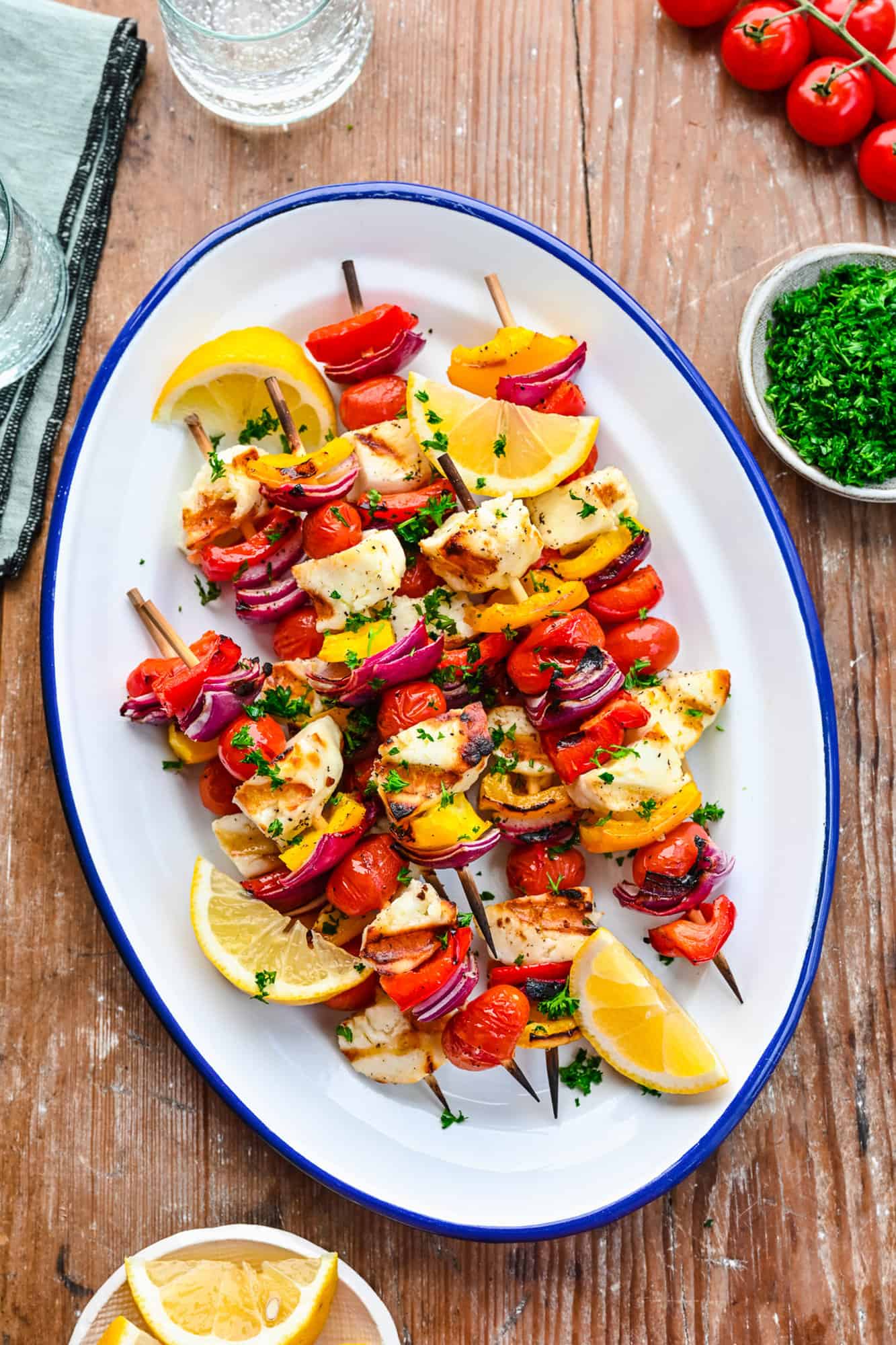 Vegetable and halloumi kebabs on a platter.