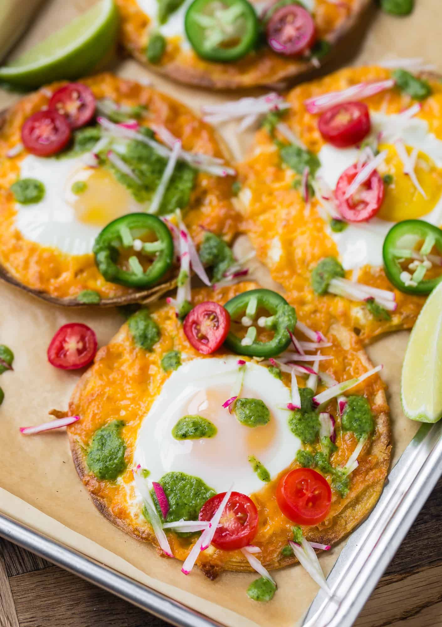 Breakfast tostada with egg, cheese, tomato, salsa verde.