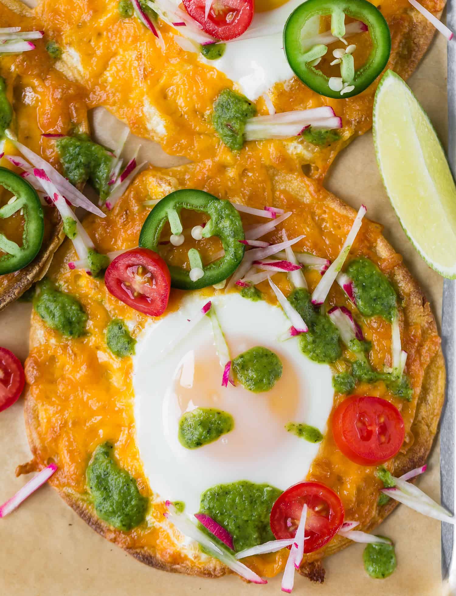 Sheet pan breakfast tostada with egg, salsa verde, toppings.