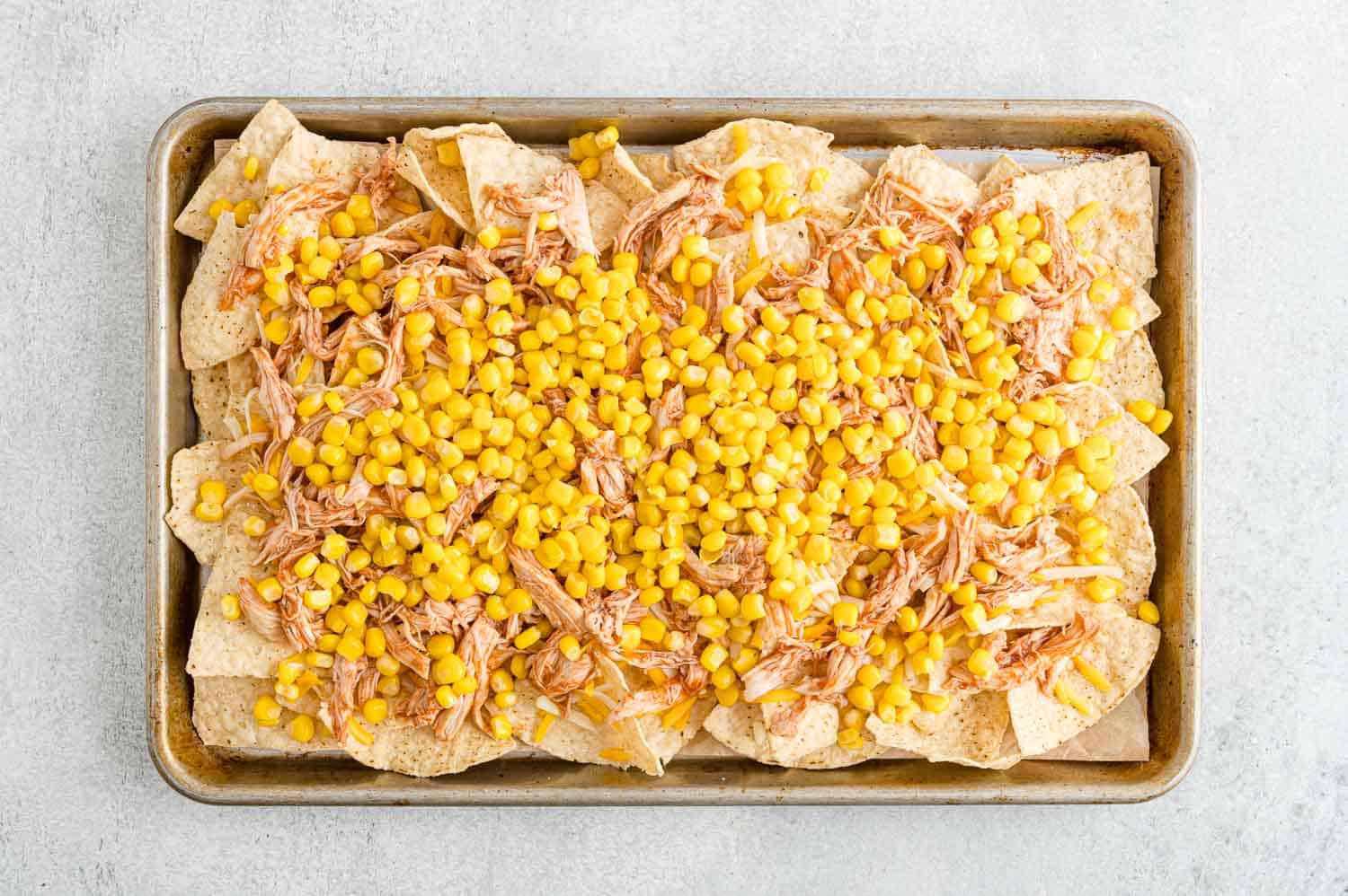 Corn added to nachos.